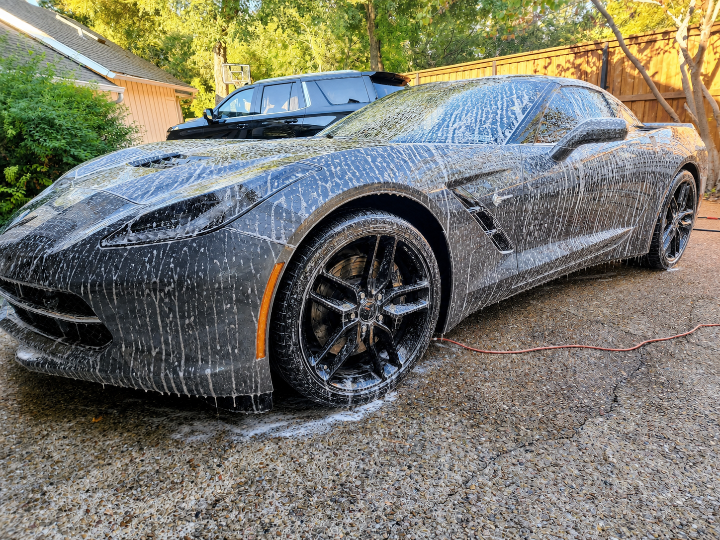 Gray Corvette covered in car-wash foam