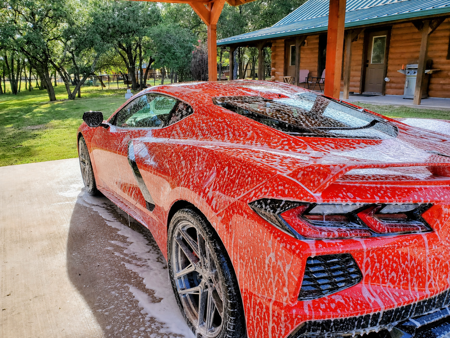 Red Corvette covered in car-wash foam